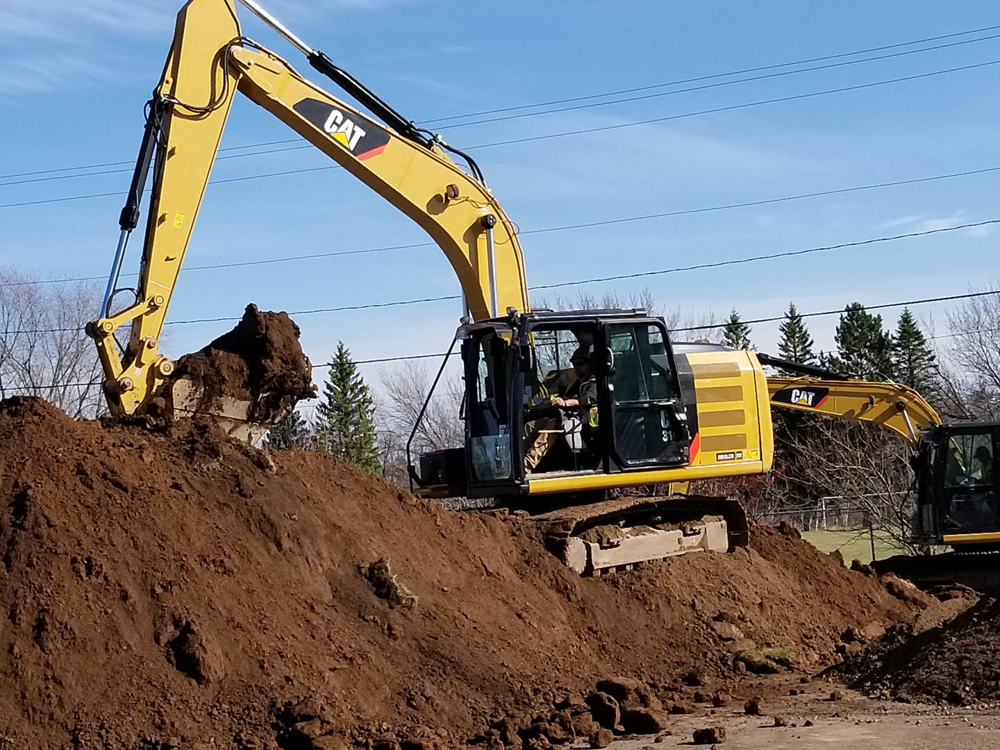 An excavator doing construction in the dirt