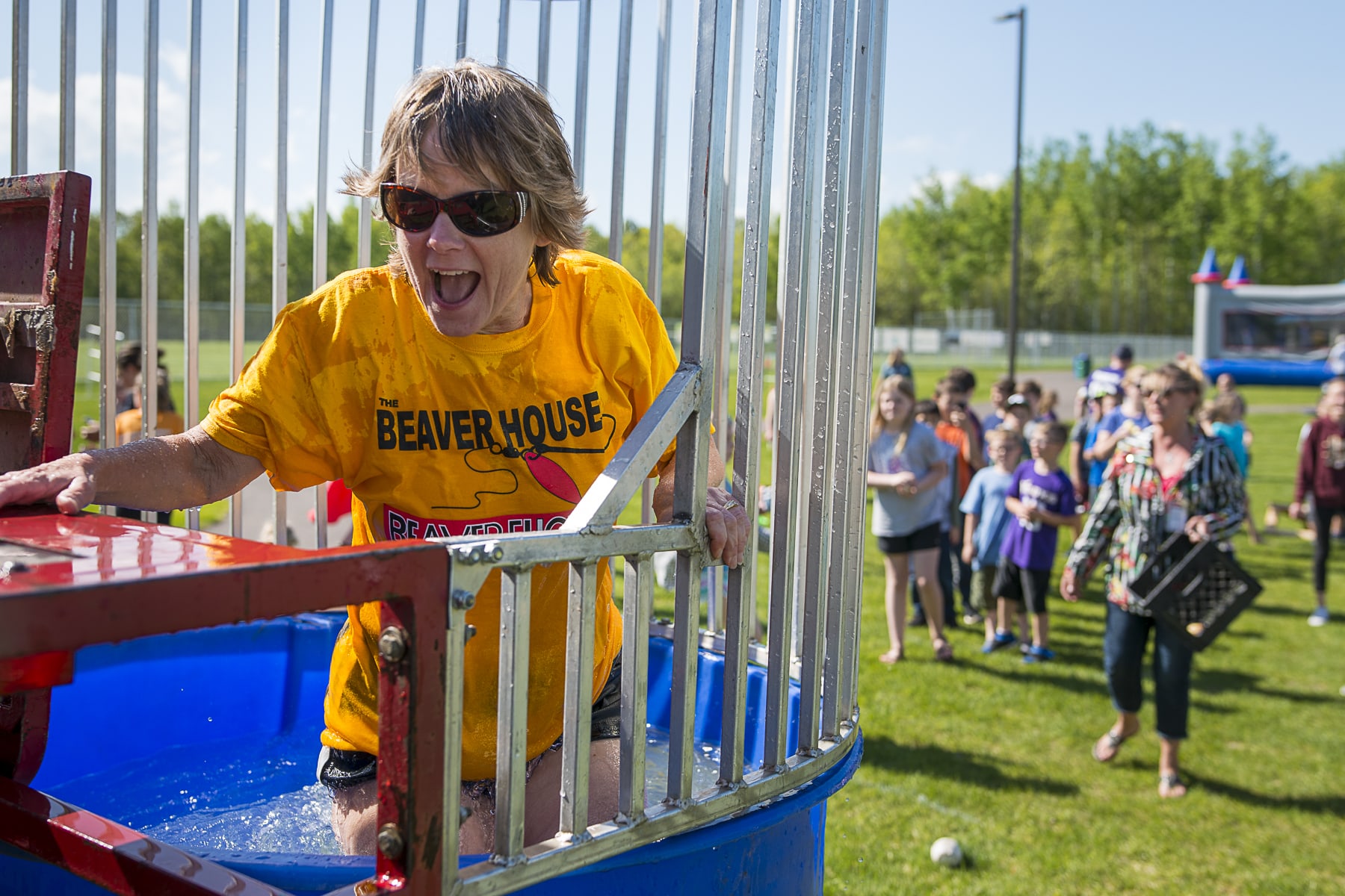 A woman in a yellow shirt gets up after being dunked in the dunk tank at the GND REC