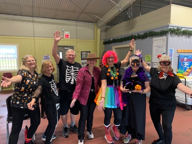 People posing for a photo in costume in the GND REC community building